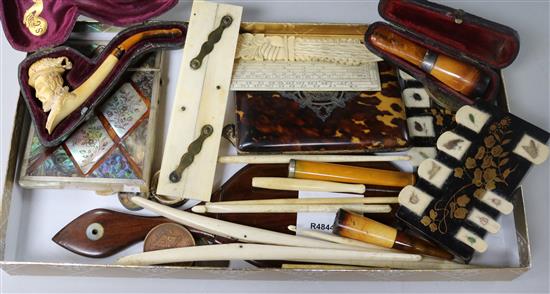 A collection of curios including a meerschaum pipe and two card cases